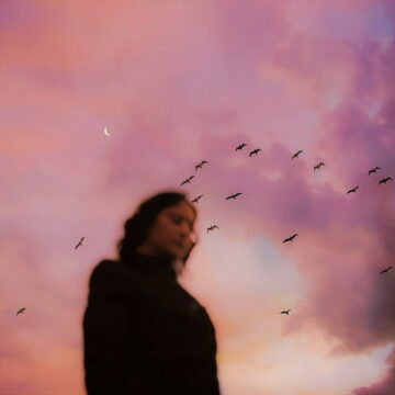 Image of a woman under the sky feeling disconnected and sad