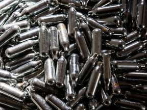 FILE - In this photo illustration some of the thousands of empty canisters of nitrous oxide that were collected at the end of a music festival are seen on October 14, 2015 in Bristol, England.